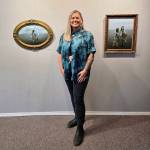 Homer photographer Amaia Nicole Crain poses with her art during her First Friday photography exhibit opening on Aug. 1, 2025, at Homer Council on the Arts in Homer, Alaska. Photo provided by Amaia Nicole Crain