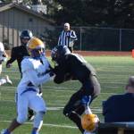 Barrow pushes Homers CJ Burns off the field on Friday, August 22. (Chloe Pleznac/Homer News)