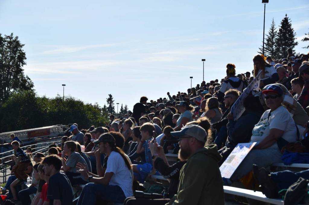 A large crowd watches the home game on Friday, August 22. It spanned all sets of bleachers and stretched across the sunny, grassy areas too. (Chloe Pleznac/Homer News)