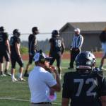Homer High School Athletic Director and Head Coach, Justin Zank, listens to another coach. (Chloe Pleznac/Homer News)
