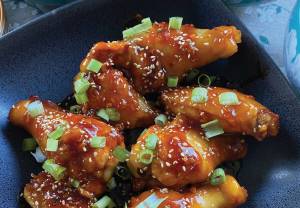 These chicken wings are sweet, mildly spicy, and fragrant with fresh ginger and garlic. (Photo by Tressa Dale/Peninsula Clarion)