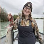Lily Craig, youth winner of the Ninth Annual Kenai Silver Salmon Derby, stands with a coho on the Kenai River. (Photo provided by Nathaniel Craig)
