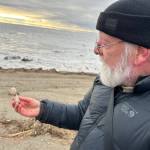 Archaeologist Rick Knecht holds a human figure that he found on the beach near the village of Quinhagak on Oct. 24, 2025. Photo courtesy Alice Bailey