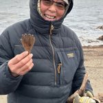 Quinhagak resident Sarah Brown holds a mask attachment she found on the beach on Oct. 24, 2025. This item might represent a hand or fin of an animal or spirit being. Photo courtesy Alice Bailey