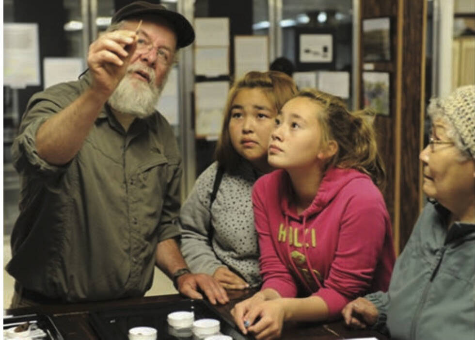Archaeologist Rick Knecht shows finds from Nunalleq to Quinhagak residents at a show-and-tell session in 2015. Photo courtesy Erik Hill/Alaska Dispatch News