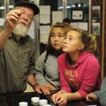 Archaeologist Rick Knecht shows finds from Nunalleq to Quinhagak residents at a show-and-tell session in 2015. Photo courtesy Erik Hill/Alaska Dispatch News
