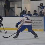 Homer freshman Landon Dehling (2) squares off against a Soldotna player in control of the puck during the Carlin Cup home varsity game on Saturday, Dec. 13, 2025, at the Kevin Bell Arena in Homer, Alaska. (Delcenia Cosman/Homer News)