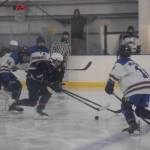 Homer and Soldotna hockey players battle for the puck during the Carlin Cup home varsity game on Saturday, Dec. 13, 2025, at the Kevin Bell Arena in Homer, Alaska. (Delcenia Cosman/Homer News)