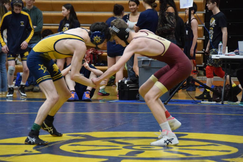A Homer athlete wrestles against a Grace Christian athlete during the regional Kachemak Conference Wrestling Championships on Saturday, Dec. 13, 2025, at Homer High School in Homer, Alaska. (Delcenia Cosman/Homer News)