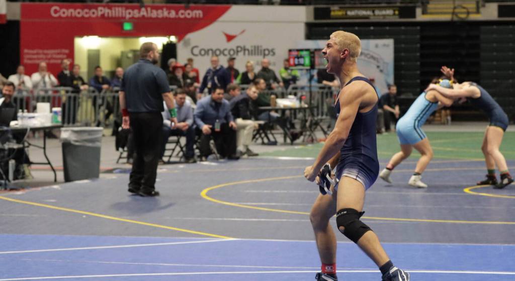 Photo courtesy of Andie Bock/Andies Alaskan Adventures Photography
Senior Mason Bock celebrates after winning the state title during the ASAA Division I state championships in Anchorage on Dec. 20. Bock beat No. 2 seed Isaiah Schultz of Colony High School in the final, securing his victory in the 135-pound title as the No. 4 seed. Bock said standing on the podium was the best moment of his life, telling the Clarion that since he had lost to Schultz once earlier in the season, he was focused and determined to have a different outcome during the final match.