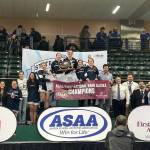 Photo courtesy of Andie Bock/Andies Alaskan Adventures Photography
The Soldotna High School girls wrestling team stands on the podium after winning the state championships in Anchorage on Dec. 20. The girls won their third state title in a row, securing the programs first ever three-peat victory.