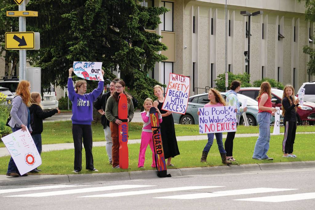 Swimmers and parents protest the proposed closure of Kenai Peninsula Borough School District pools outside of the Kenai Peninsula Borough Administration Building in Soldotna, Alaska, on Thursday, June 26, 2025. (Jake Dye/Peninsula Clarion)