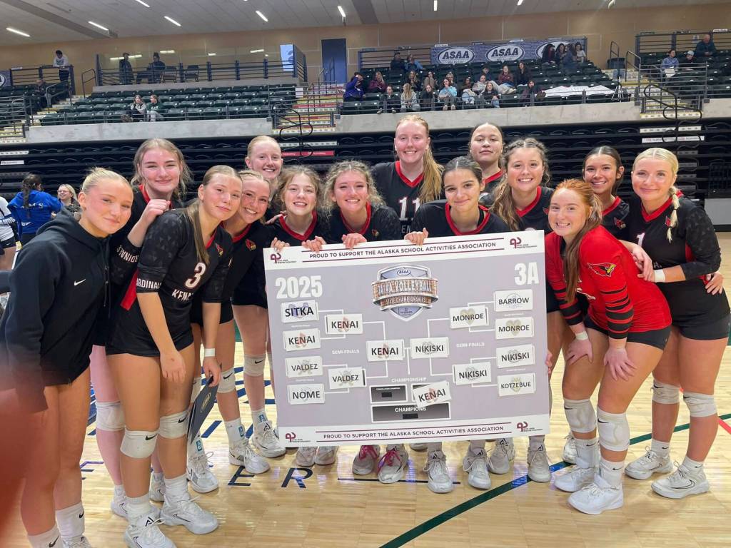 The Kenai Central High School varsity volleyball team holds up the 3A state tournament bracket following the results of the semifinal game on Friday, Nov. 14, 2025, at the Alaska Airlines Center in Anchorage, Alaska. Photo courtesy of the Kenai Volleyball Booster Club