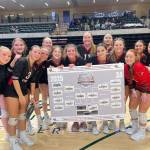 The Kenai Central High School varsity volleyball team holds up the 3A state tournament bracket following the results of the semifinal game on Friday, Nov. 14, 2025, at the Alaska Airlines Center in Anchorage, Alaska. Photo courtesy of the Kenai Volleyball Booster Club