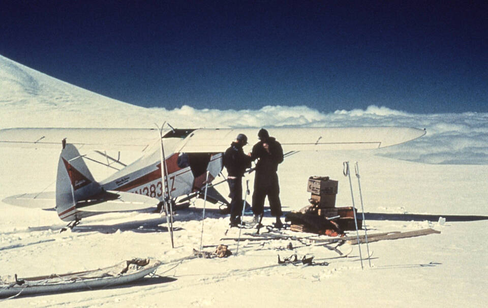 Carl Benson, right, and pilot Jack Wilson of Copper Center confer after landing near the summit of 14,000-foot Mount Wrangell. Photo courtesy of the UAF Geophysical Institute