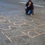 Macelle Joseph, a member of the Juneau-Douglas High School: Yadaa.at Kalé chapter of Alaska Youth for Environmental Action, writes Its Native blood in the soil, not your oil outside the Alaska State Capitol building on Jan. 24<ins>, 2026</ins>. Dozens of Juneauites participated in the student-led protest against the LNG pipeline.