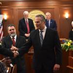 Governor Dunleavy shakes hands with a representative as he exits from his final State of the State address on Thursday evening, Jan. 22, 2026. (Mari Kanagy/Juneau Empire)