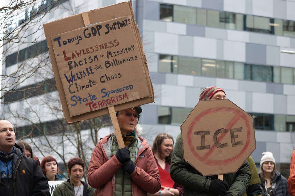 Protesters hold signs at the Dimond Courthouse plaza during an anti-ICE protest on Jan. 29, 2026. (Chloe Anderson/Juneau Empire)