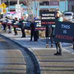 Protesters form a line on the sidewalk along Pioneer Avenue as they hold This is fascism signs during the ICE OUT demonstration on Sunday, Feb. 1, 2026, at WKFL Park in Homer, Alaska. (Delcenia Cosman/Homer News)