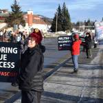 Protesters line up on the sidewalk along Pioneer Avenue and carry This is fascism signs during the ICE OUT demonstration on Sunday, Feb. 1, 2026, at WKFL Park in Homer, Alaska. (Delcenia Cosman/Homer News)