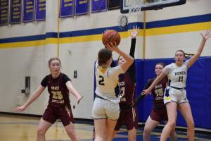 Sophomore Abby Ostrom seeks to pass the ball to senior Keagan Niebuhr during the varsity game against Grace Christian on Saturday, Feb. 7, 2026, during the annual Winter Carnival basketball tournament in the Alice Witte Gymnasium at Homer High School in Homer, Alaska. (Delcenia Cosman/Homer News)