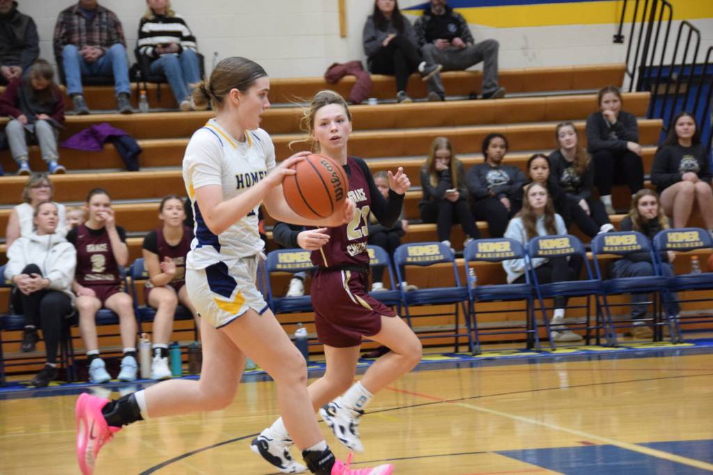 Sophomore Abby Ostrom runs the ball down the court during the varsity game against Grace Christian on Saturday, Feb. 7, 2026, during the annual Winter Carnival basketball tournament in the Alice Witte Gymnasium at Homer High School in Homer, Alaska. (Delcenia Cosman/Homer News)
