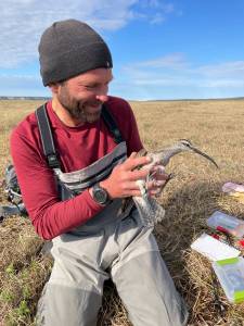 In 2021, the late Shiloh Schulte holds a whimbrel that nested above the Katakturuk River in northern Alaska. Photo courtesy Kirsti Carr